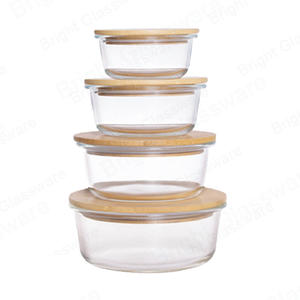 Caja de conservación de vidrio resistente al calor de forma redonda Recipiente de vidrio para alimentos borosilicato con tapa de madera